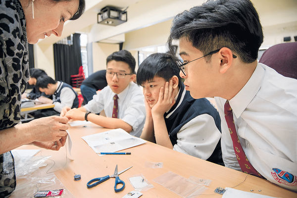 An American teacher is teaching international students in class.