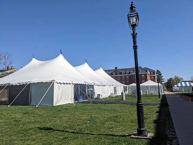 Tents pitched on a university lawn.